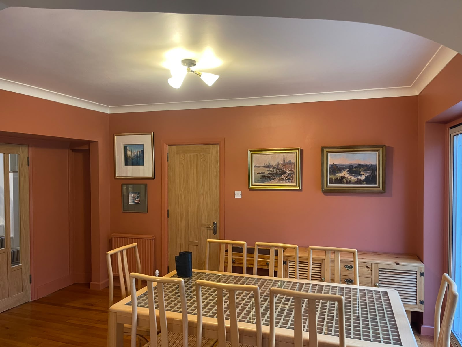 Terracotta dining room with white ceiling, cornice and oak trim