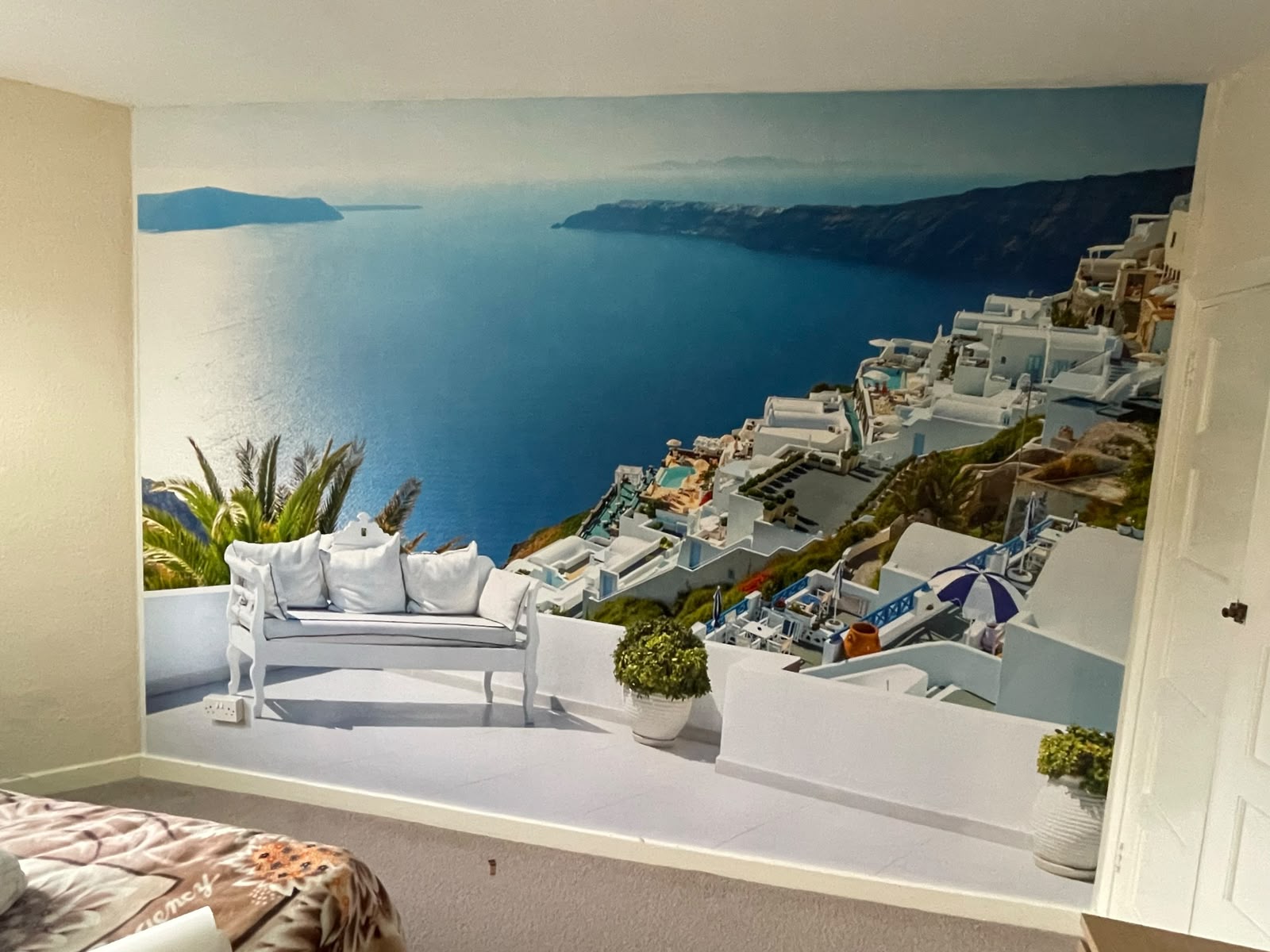 Bedroom feature wall with a Santorini coastal mural wrapping the alcove