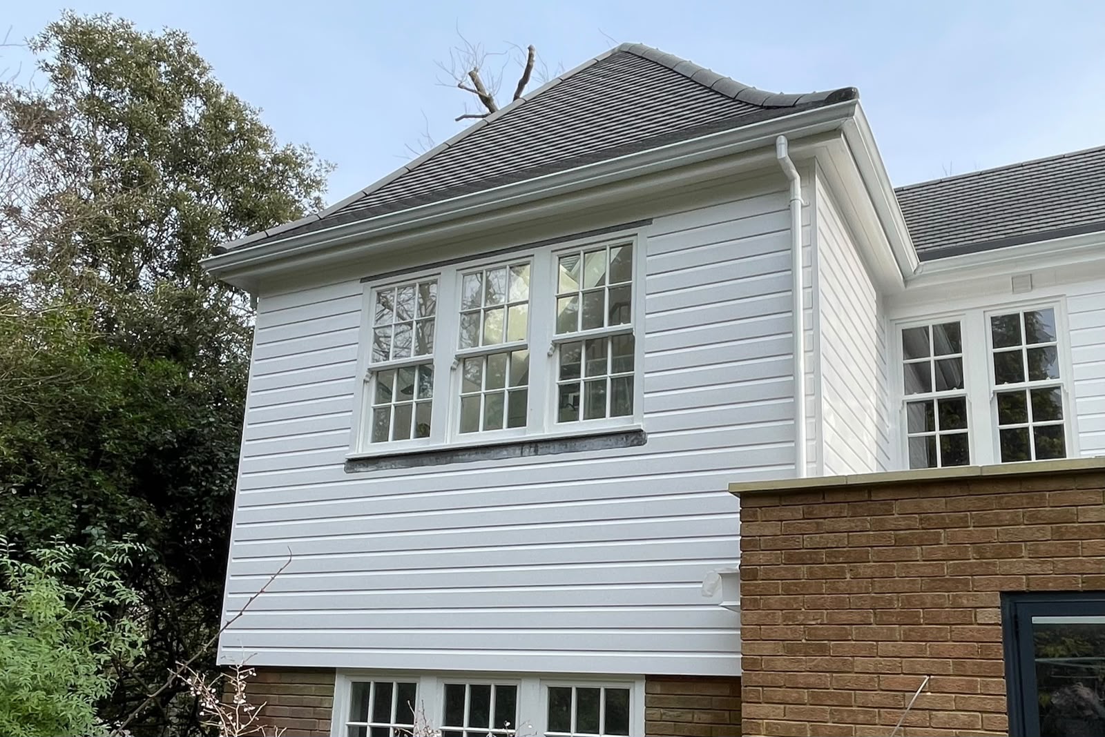 White painted timber cladding on a period home with fresh white sash windows