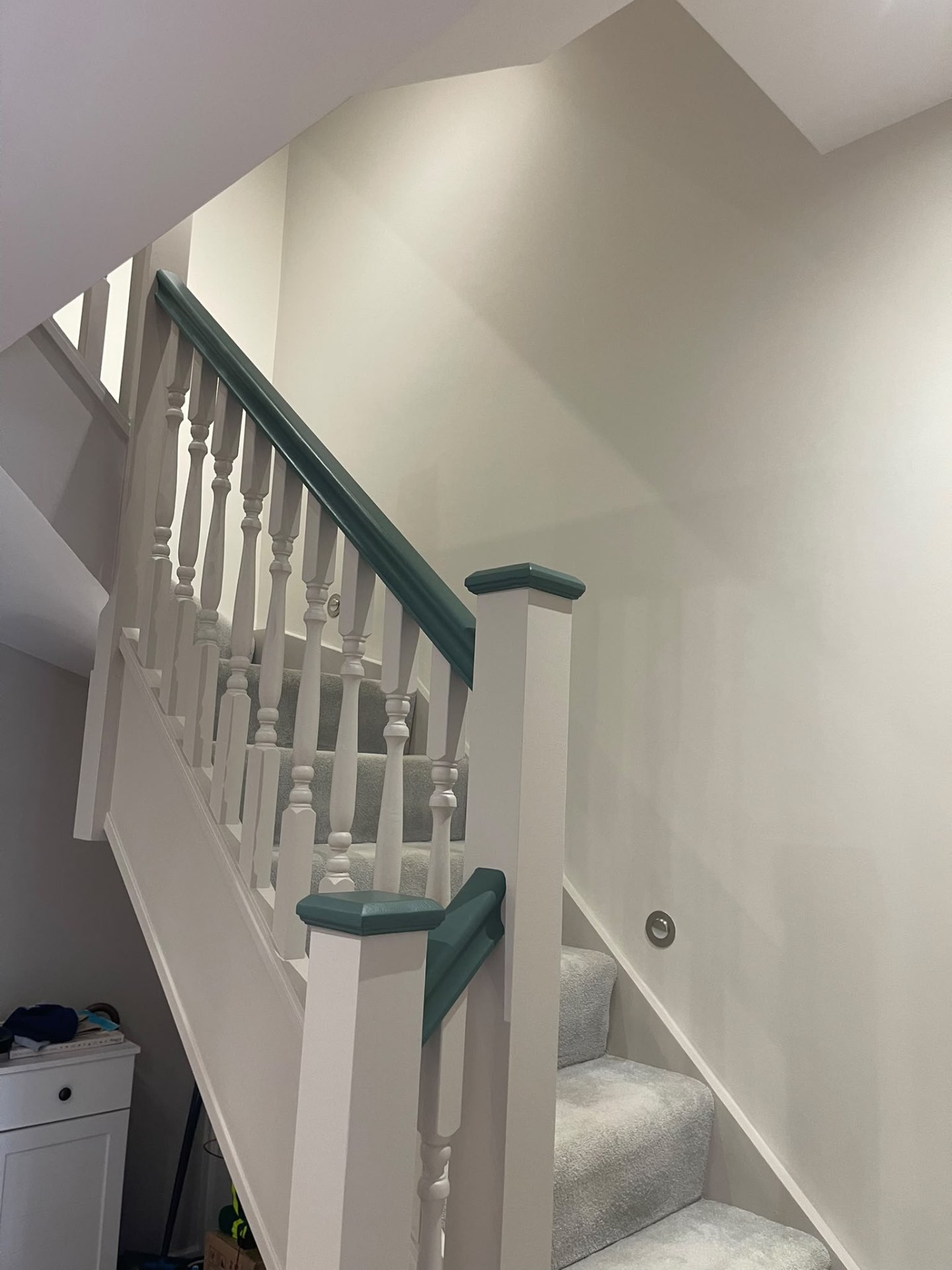 Completed stairwell with painted walls, woodwork and contrasting dark green staircase details