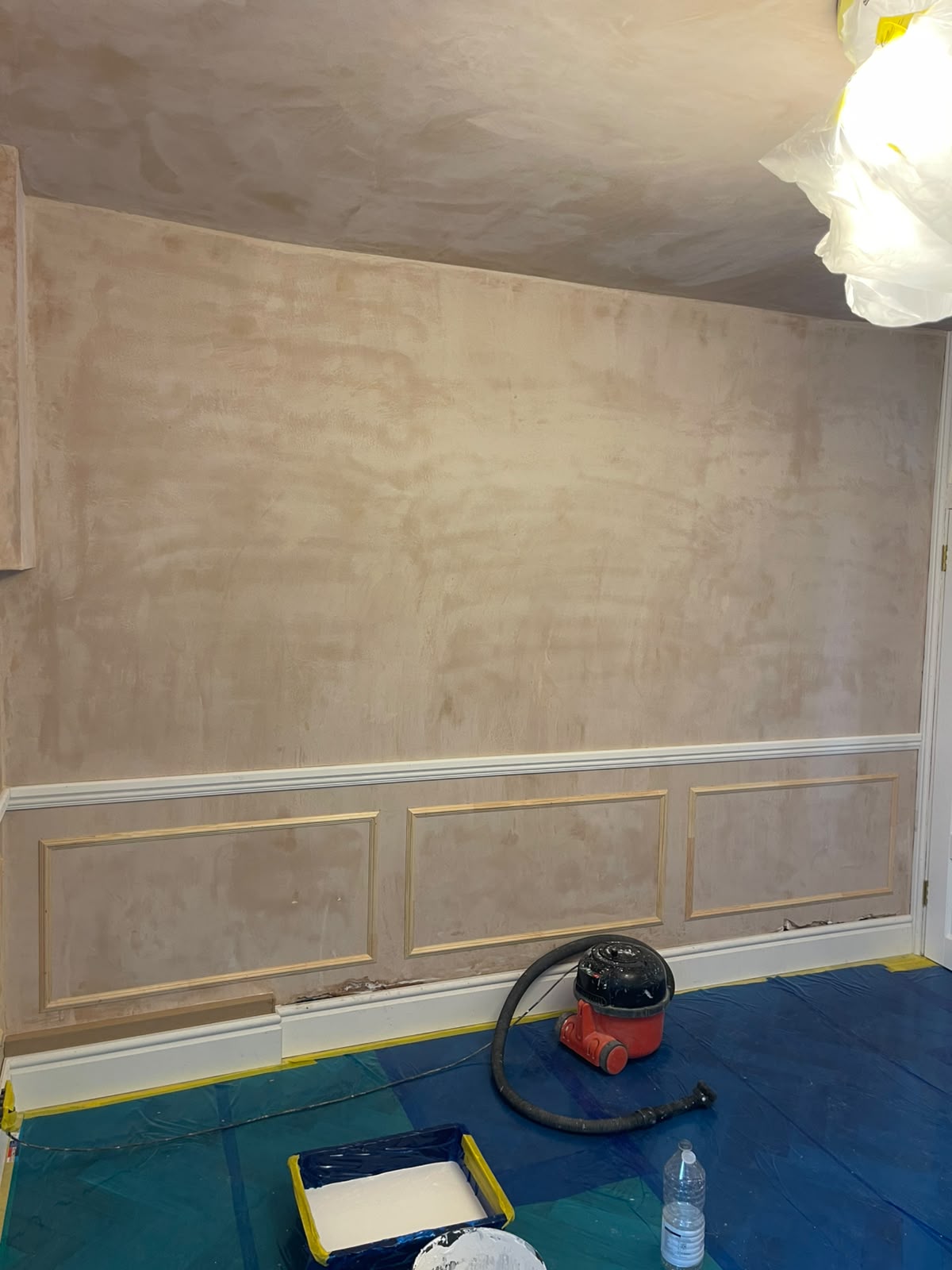 Wall with three timber wainscoting panels installed below a decorative dado rail
