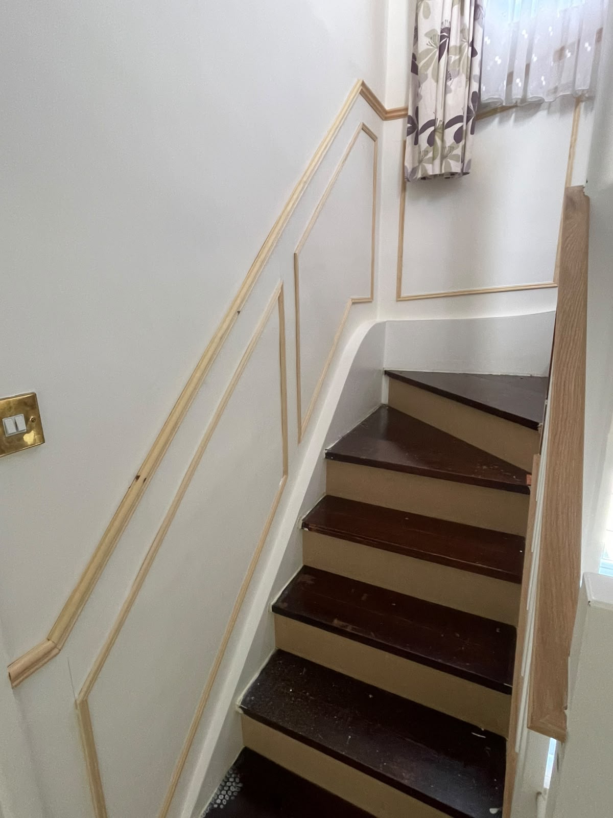 Staircase with bespoke timber panelling following the diagonal of the stairs