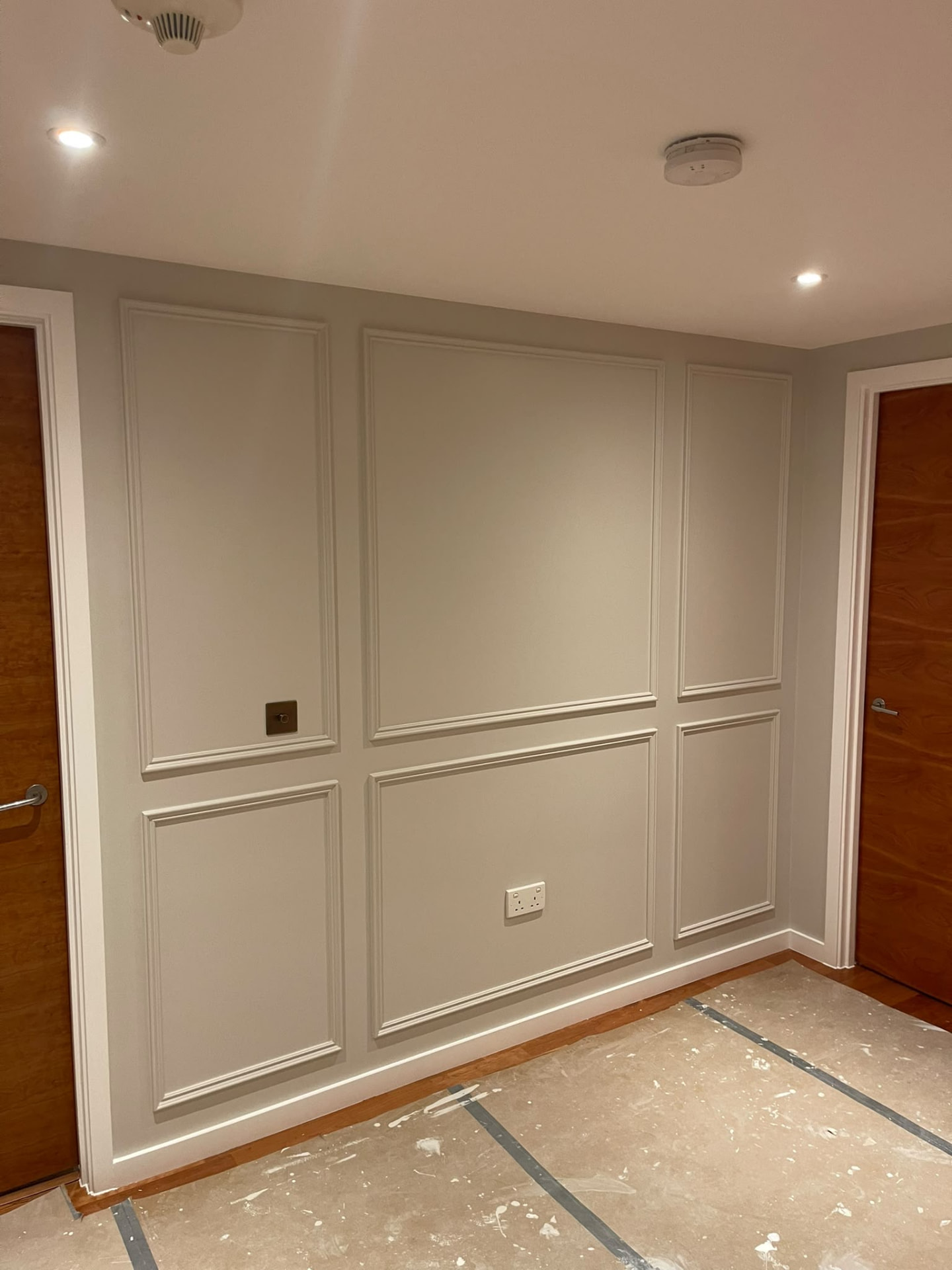 Painted wall mouldings and cornice in Islington with temporary floor protection still in place