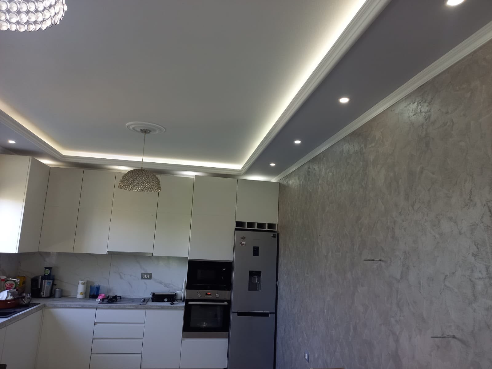 Kitchen with LED cove lighting, decorative cornice and Venetian plaster feature wall