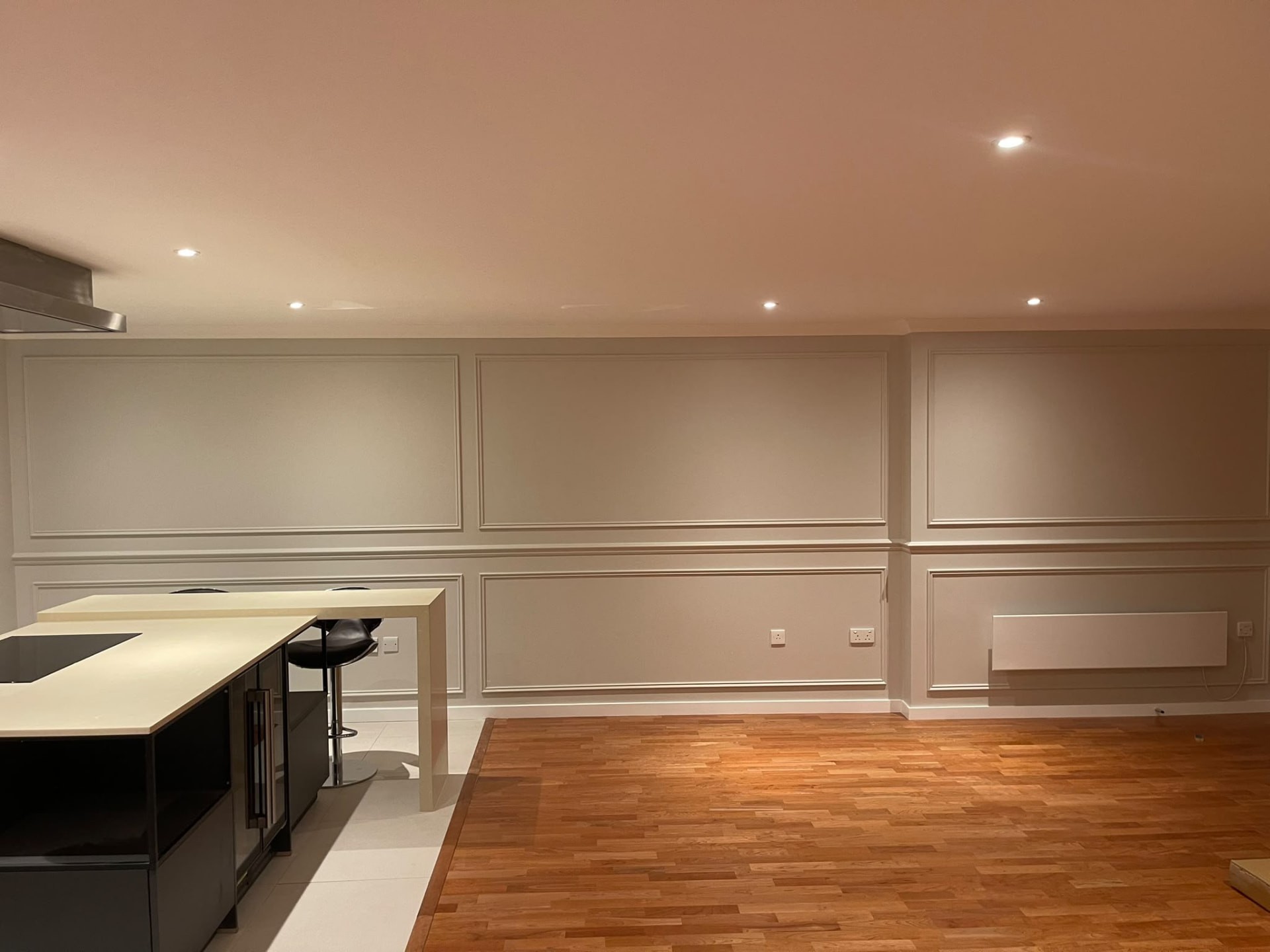 Completed Islington living area with neutral painted walls, rectangular decorative mouldings, cornice and exposed wooden floor