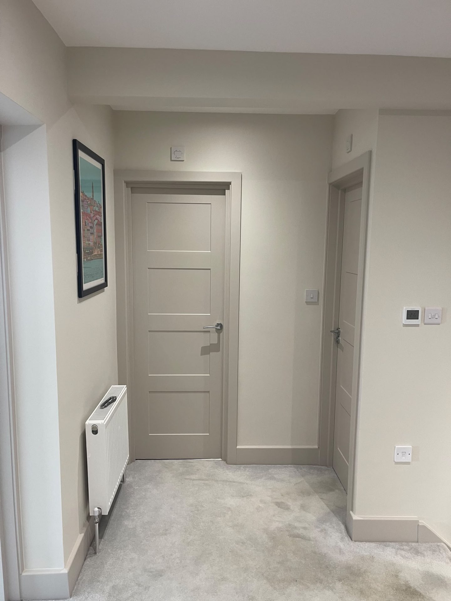 Painted hallway in a Hersham home with finished walls, ceiling, doors, frames and skirting boards
