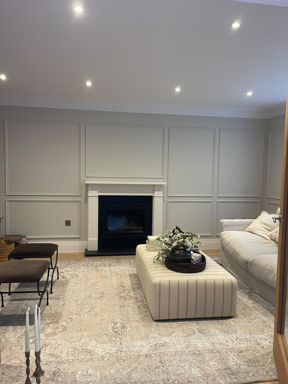 Completed decorative wall panelling around a fireplace in a living room in Hinchley Wood, Surrey